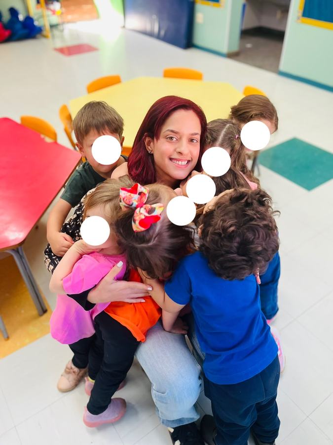 Beatriz hugged by her students